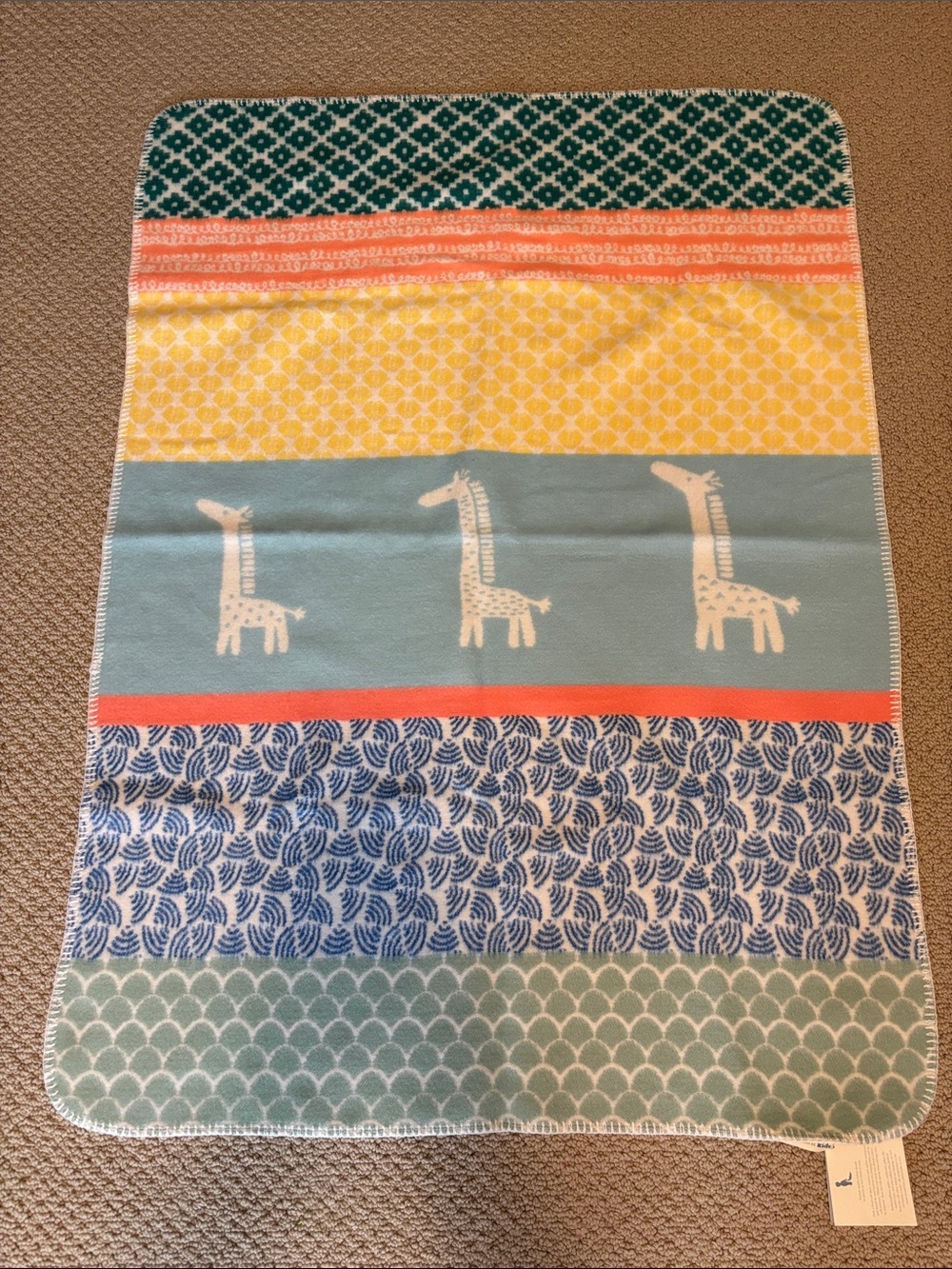 NWT Pottery Barn Kids Baby Blanket with a colorful Giraffe Pattern
